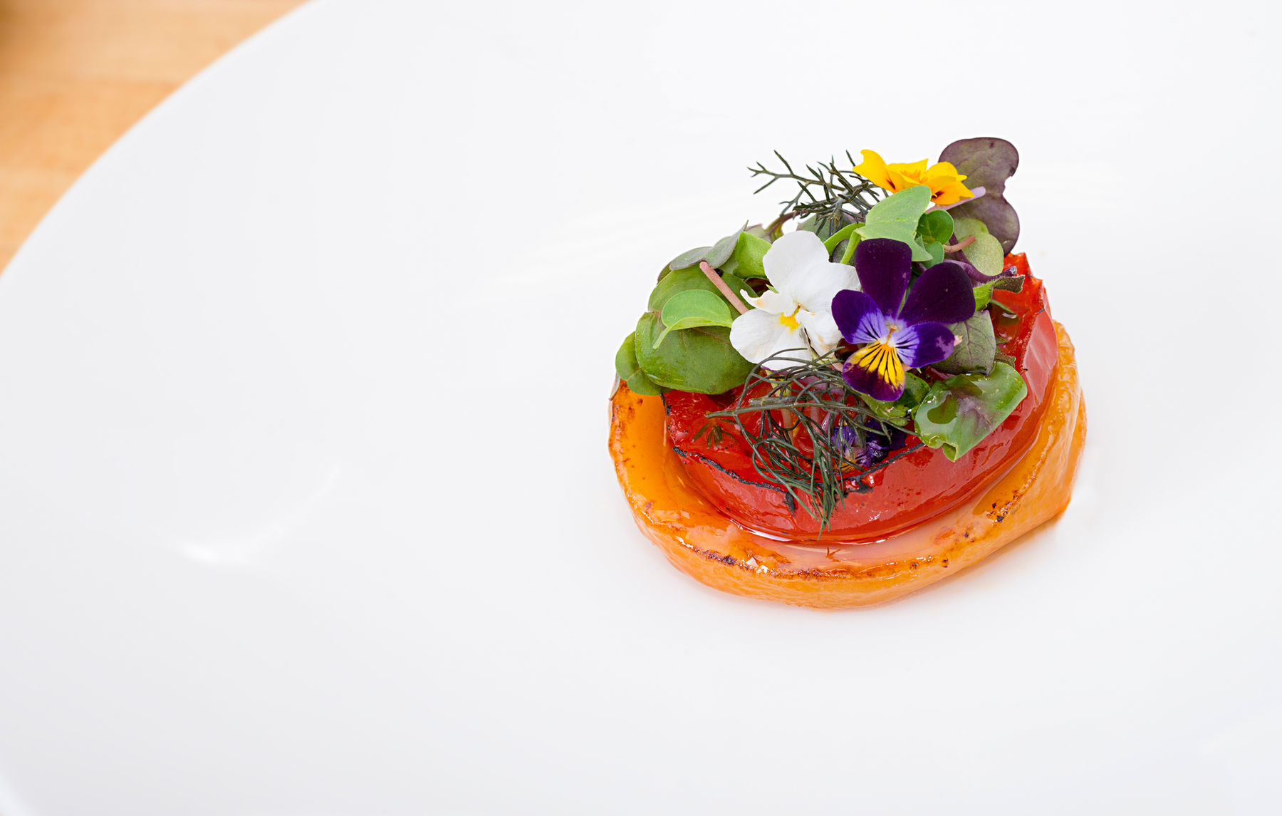 Plated seasonal course finished with edible flowers