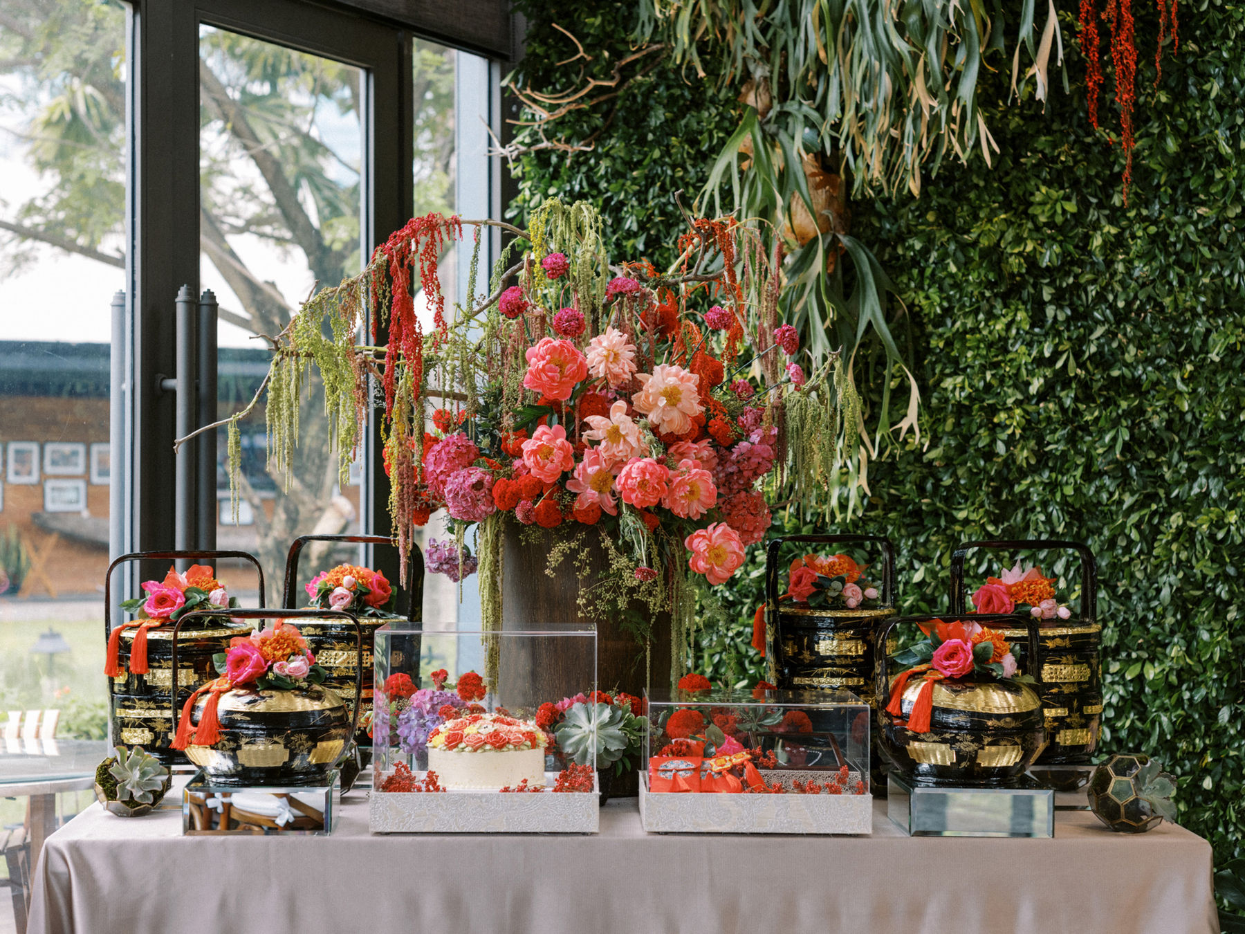 Styled dessert and grazing display against a greenery wall
